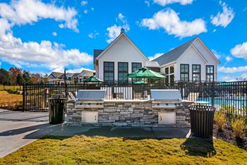 Additional outdoor courtyard with covered grill station & farm tables, lounge seating, and hammocks